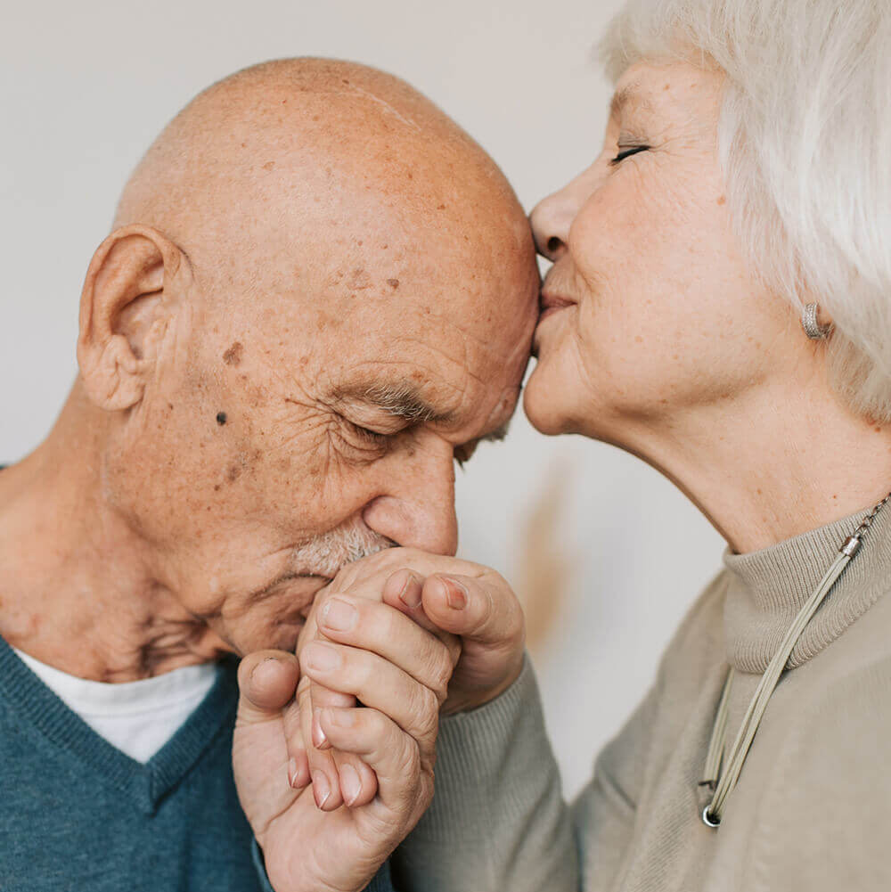 An older woman and man embracing each other.